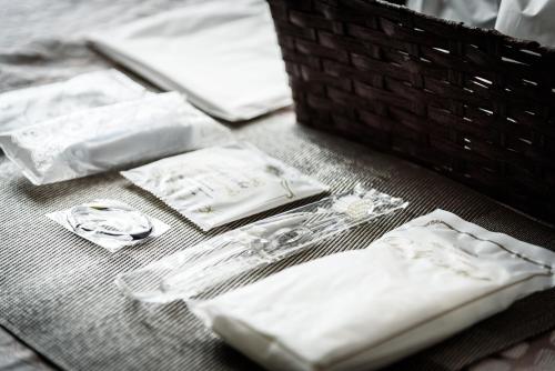 a table with white towels and napkins on it at Cocostay The Peace Memorial Park ココステイ平和記念公園 Excellent location overlooking Peace Park! in Hiroshima