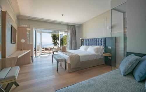 a bedroom with a bed and a view of the ocean at Golfo dei Poeti Relais & Spa in Ameglia