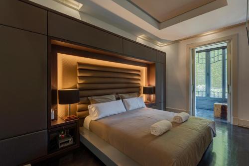 a bedroom with a large bed with a large headboard at SuiteaBcn II in Barcelona