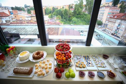 a table with many different types of food on it at City Boutique Hotel in Sarajevo