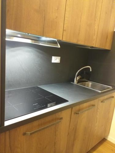 une cuisine avec un évier et un plan de travail dans l'établissement Residence Garden Appartamenti Solandra, à Mezzana