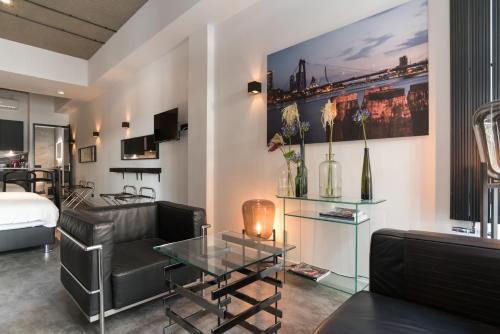 a living room with a couch and a table at Midtown Hotel Rotterdam in Rotterdam