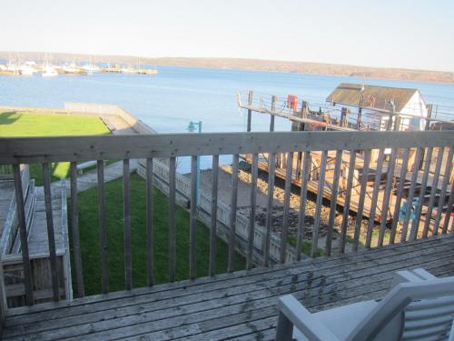 a wooden deck with a view of the water at Shoreline Suites in Digby