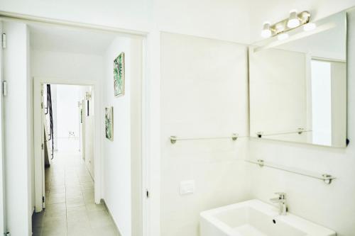 a white bathroom with a sink and a mirror at VILA AMALIE - 3BDR+3 BATH in Amarilla Golf in San Miguel de Abona