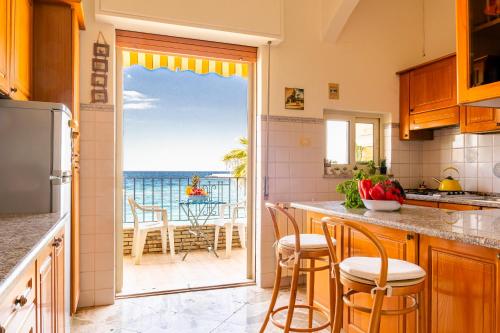 a kitchen with a view of the ocean at La Casa di Elvira in Giardini Naxos