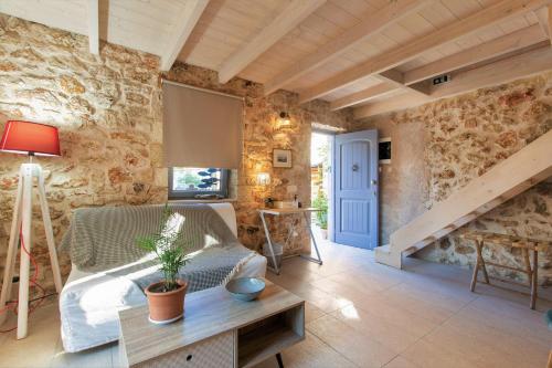 a living room with a bed and a table at Luxurious bungalow in Ipsos beach in Ýpsos