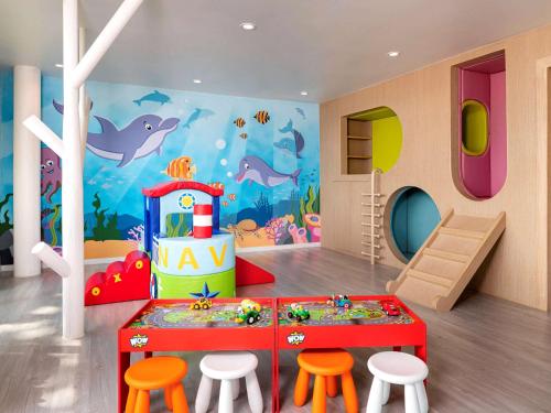 a childs play room with a dolphin wall mural at Novotel Rayong Rim Pae Resort in Klaeng