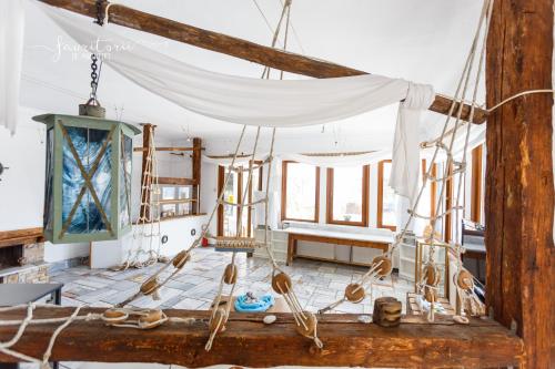 a room with a white canopy and a room with windows at Kinira Beach Hotel in Koinyra