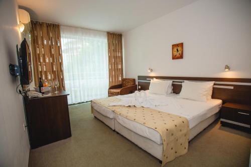 a hotel room with a bed and a television at Deva Hotel - All Inclusive in Sunny Beach