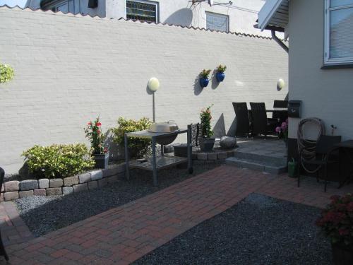 a patio with a table and chairs next to a building at Odense Apartments in Odense