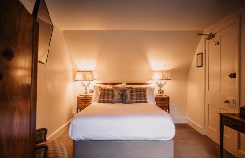 a bedroom with a large bed with two lamps at Shieldaig Lodge Hotel in Gairloch