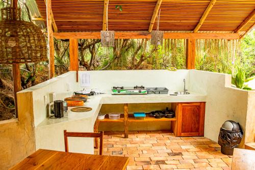 a kitchen with a table and a counter top at Tofinho Beach House Apartments in Inhambane