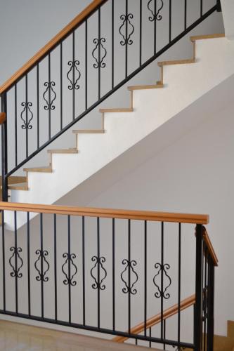 a staircase with black wrought iron railings and white stairs at Gran Hotel Toledo in Onda
