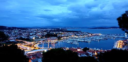 a harbor with boats in the water at night at Apartments Danijela in Tribunj