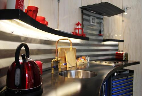 a kitchen sink with a tea kettle on top of it at SiloStay in Little River