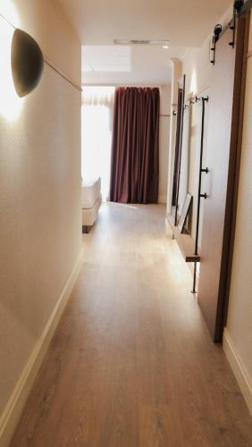 a room with a hallway with a mirror and a window at JovA Hotel Boutique in El Campello