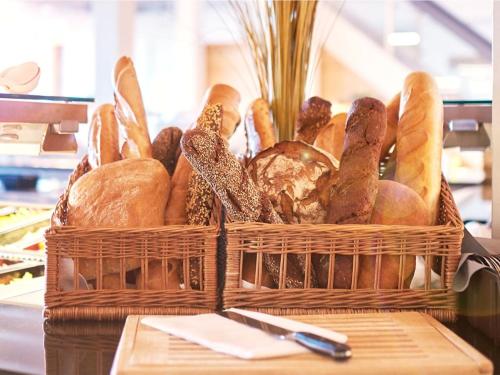 a basket filled with lots of different types of bread at Premium Haus in Damp