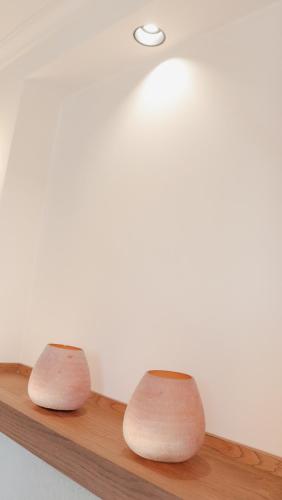 two vases sitting on a wooden shelf at JovA Hotel Boutique in El Campello