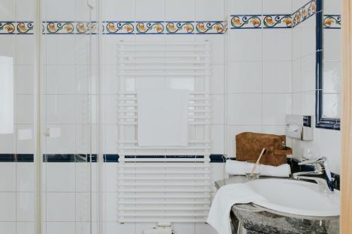a bathroom with a sink and a shower at Hotel Tauernhof in Grossarl