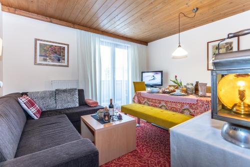 a living room with a couch and a table at Haus Alexandra in Werfenweng