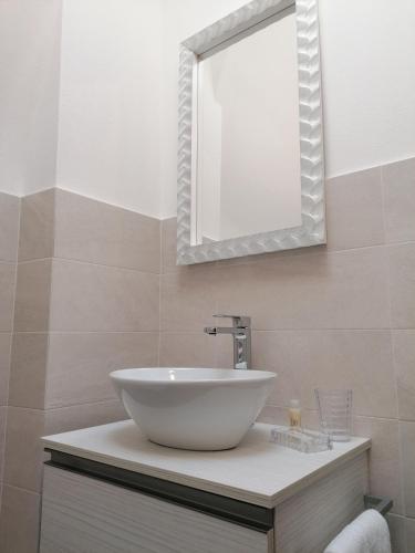 a bathroom with a white sink and a mirror at P in centro in Sestri Levante