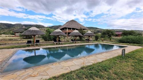 a swimming pool in front of a resort at Africa Safari Lake Natron in Mtowabaga