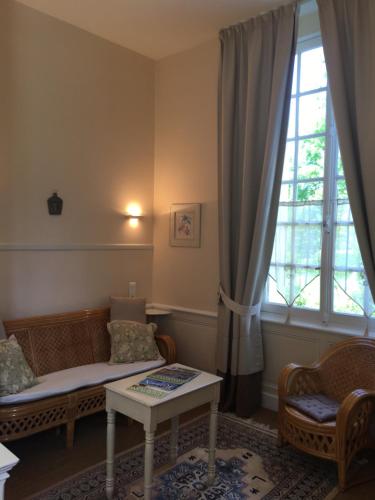 a living room with a couch and a window at Chambres d'Hôtes & Gites La Chatellenie in Saint-Aubin-le-Cauf