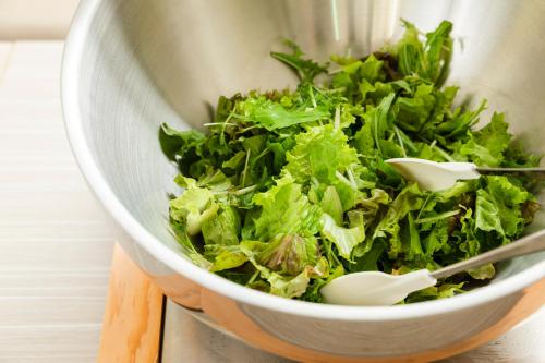 a bowl of lettuce with two utensils in it at Sotetsu Fresa Inn Yokohama Sakuragi-cho - Renovated in June 20th 2025 in Yokohama