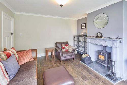 a living room with a couch and a fireplace at Host & Stay - The Moorings in Runswick