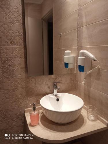 a bathroom with a white sink and a mirror at Bellarias House in Nydri