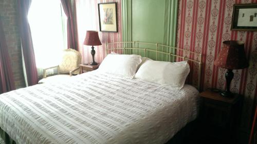 a bedroom with a bed with a white comforter at Connor Hotel in Jerome