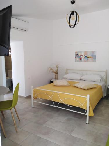 a bedroom with a bed and a table and a tv at Casa Bellissima in Chania