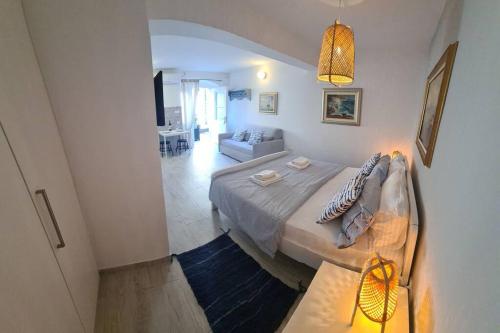 a bedroom with a bed and a living room at Studio Apartment Marella in Vis