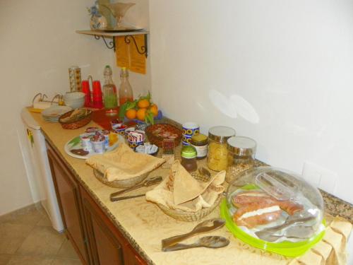 a kitchen counter with food on top of it at Cloris Guest House in Noto
