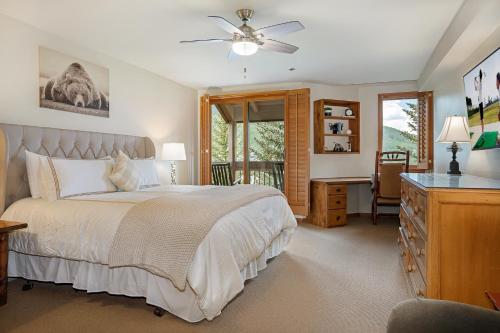 a bedroom with a bed and a desk and a window at 326 Kiva Condo access to Ski in Out in Avon