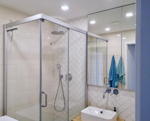 a bathroom with a shower and a sink at Homely apartment in Kėdainiai in Kėdainiai