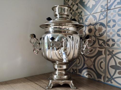 a silver trophy sitting on a floor next to a wall at Homely apartment in Kėdainiai in Kėdainiai