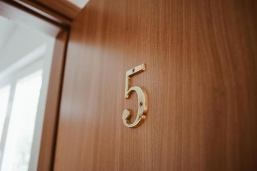 a wooden door with a number six on it at Perla Apartments in Poreč