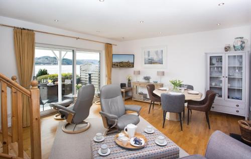 a living room with a table and chairs at Fishermans in Inverness