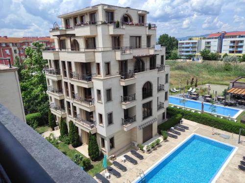 an apartment building with a pool in front of it at Apartments Amara Sunny Beach in Sunny Beach