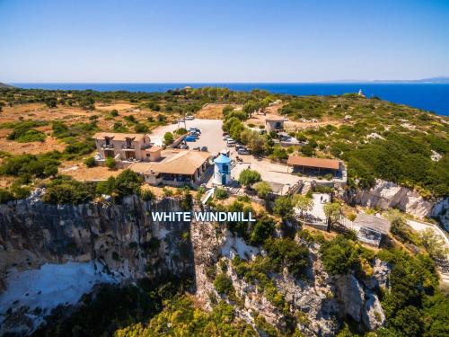 an aerial view of white wolf villa on a cliff at Potamitis Windmills & Apartments - Unique Stay with Scenic Views, by ZanteWize in Koríthion