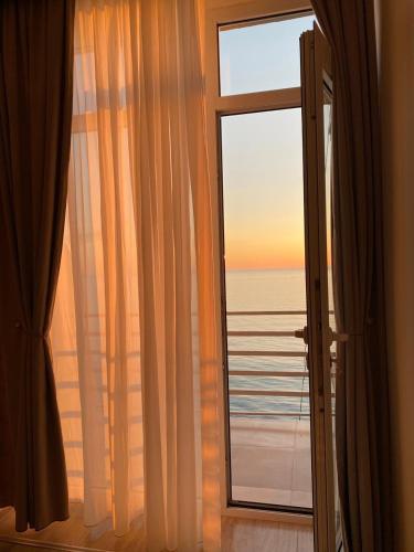 a room with a window with a view of the ocean at GONIO apartment in Gonio
