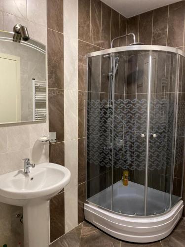 a bathroom with a shower and a sink at GONIO apartment in Gonio