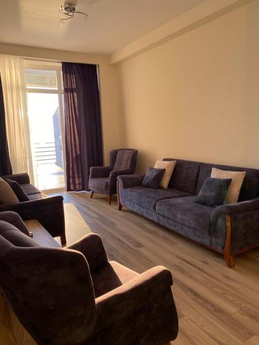 a living room with a couch and two chairs at GONIO apartment in Gonio