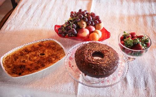 a table with a plate of food and a bowl of fruit at Casa De Carcavelos in Cabeceiras de Basto