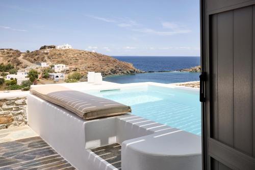 a swimming pool with a view of the ocean at Wise Luxury Suites in Kithnos