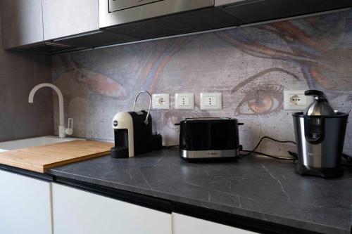 a kitchen with a counter top with a toaster and a appliance at 051 Guest House Sant'Orsola Malpighi in Bologna