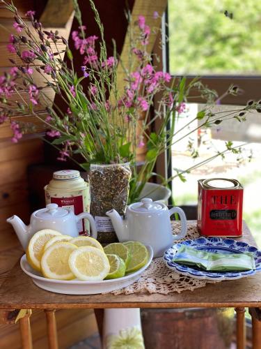 a table with a plate of lemons and teapots at Hôtel de famille L.F.M.A.L. in Giat