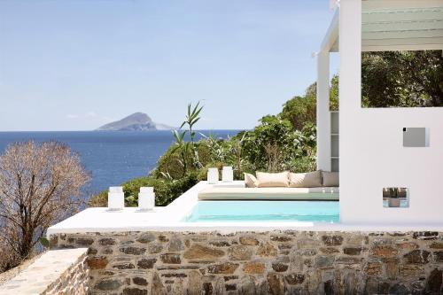 a villa with a swimming pool and the ocean at Wise Luxury Suites in Kithnos