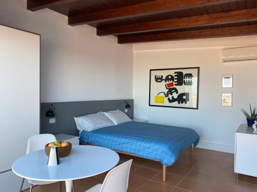 a bedroom with a bed and a table at Osservatorio sul mare in Bari